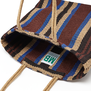 Detail of the inside of a jute bag with a striped pattern in blue, brown and dark red. 